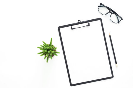 Creative flat lay photo of workspace desk. Top view office desk with glasses, pencil, blank...