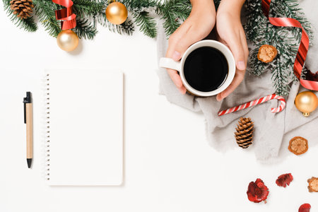 Minimal creative flat lay of winter christmas traditional composition and new year holiday season. Top view open mockup black notebook for text on white background. Mock up and copy space photography.の写真素材