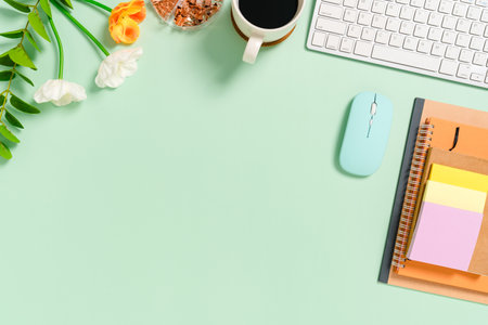Minimal work space - Creative flat lay photo of workspace desk. Top view office desk with keyboard, mouse and notebook on pastel green color background. Top view with copy space, flat lay photography.の写真素材