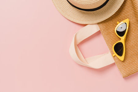 Creative flat lay photo of travel vacation spring or summer tropical fashion. Top view beach accessories on pastel pink color background with blank space for text. Top view copy space photography.の写真素材