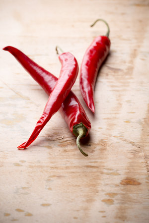 Chili pepper on the wooden background.の写真素材