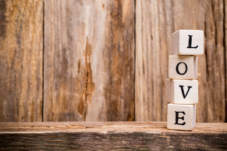 Written on wooden blocks love and red heart.の写真素材