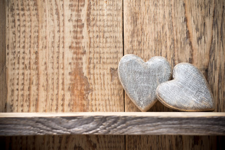 Heart on a wooden shelf. Wooden wall, studio photography.の写真素材