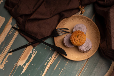 Chinese cakes are on the gray cloth of the wooden tableの写真素材
