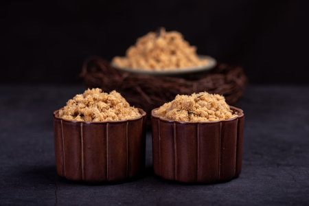 Refined fish floss in a cup against a dark background