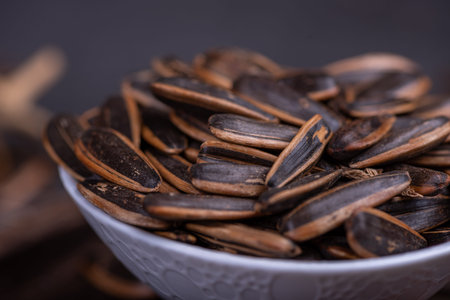 Sunflower seeds in the dark background inside the container