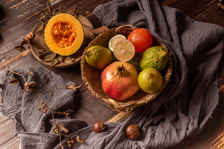 Pumpkins and many other colors and varieties of fruits and vegetables are on the wood grain tableの写真素材