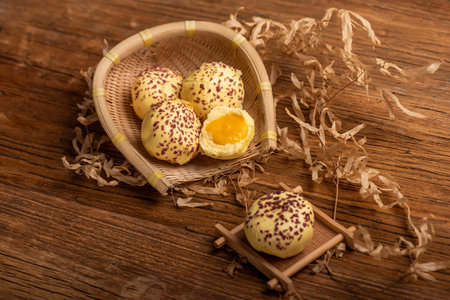 Cut and complete the egg yolk steamed stuffed bun on the wood grain table