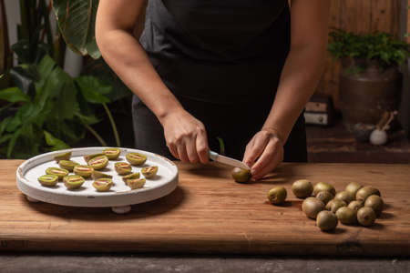 Cut ripe kiwi fruit on a wooden table.の写真素材