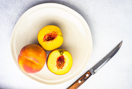 Ripe and healthy peach fruits in the bowlの写真素材