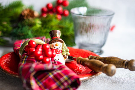 Table setting for festive Christmas dinner on concrete tableの写真素材