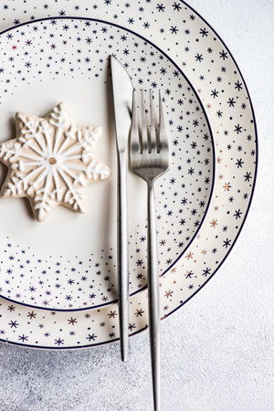 Festive place setting for holiday Christmas dinner on concrete tableの写真素材