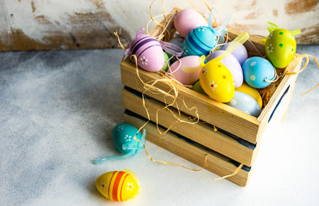 Box full of colorful eggs on rustic backgroundの写真素材