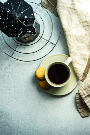 Morning cup of coffee and milk cookies served on the tableの写真素材