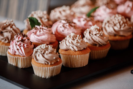 Cupcakes with curls of creamy strawberry glaze.の写真素材
