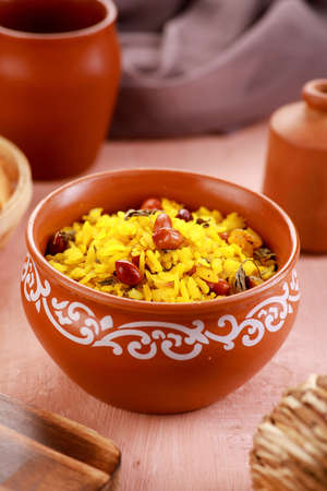 Indian Food Maharashtra Poha with Peanuts in a Pottery Bowlの写真素材