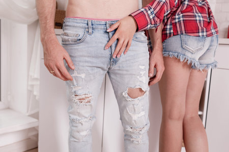 Valentine's Day. cropped photo of stylish loving couple are hugging while spending time together in kitchen at home.の写真素材