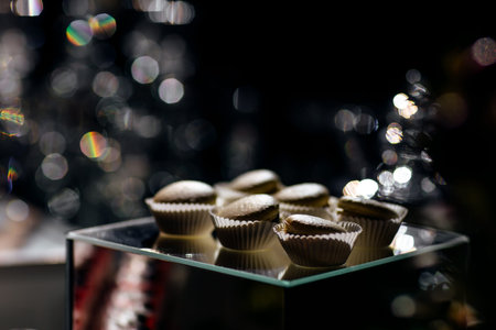 Chocolate macaroons cakes on a black background. Macaroons on black surface.の写真素材