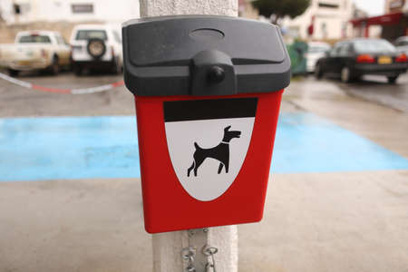 red box with packages for dogs poop outdoors.の写真素材