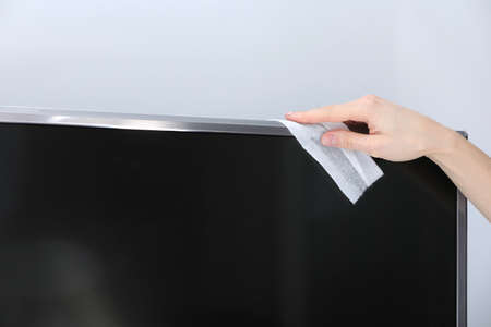 Closeup Of Young Woman Wearing Apron Cleaning Kitchen Worktop. home furniture disinfection. selective focusの写真素材