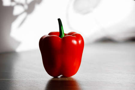 fresh red pepper on a table with sun light from kitchen window.の写真素材