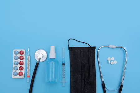 Doctor table with medical items on blue background. Flat lay. medical tools on blue background. selective focusの写真素材
