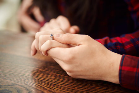 Man holding his girlfriend's hand. Man making a marriage proposal to his girlfriend - Happy engaged...