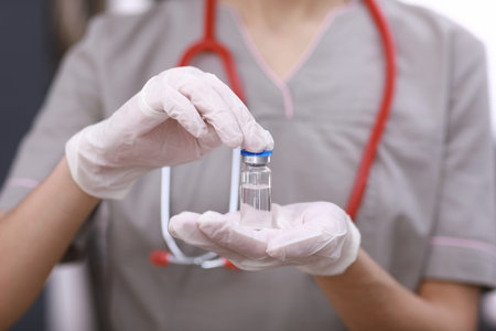 Female doctor with a stethoscope on shoulder holding