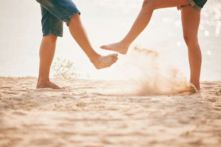 young couple playing with sand. Summer lifestyleの写真素材