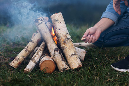 tourist man's hands kindle a fire in the mountains.