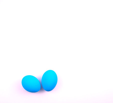 Minimal creative photography concept. Blue eggs isolated on white background. Top view, off-center composition. For your flat lay, overlays, mockup with copy space.の写真素材