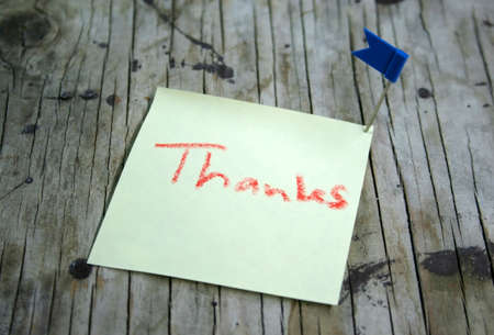 paper note on wooden backgroundの写真素材