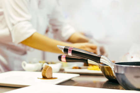 chef cooking, Chef preparing food, Chef decorating dish in the kitchenの写真素材