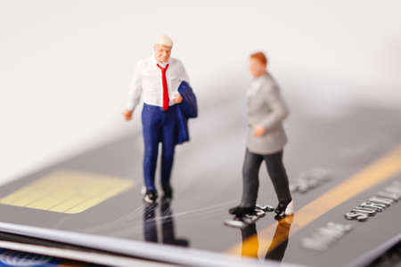Business man miniature people stand on credit card, management business finance concept.の写真素材