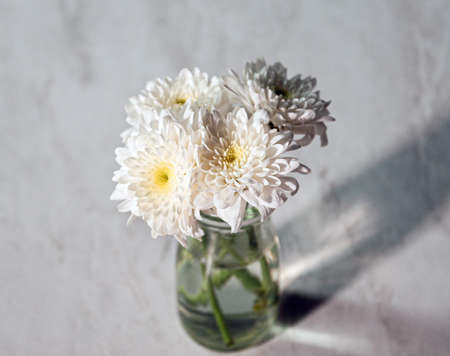 White Flower bouquet in a Vase on wooden tableの写真素材