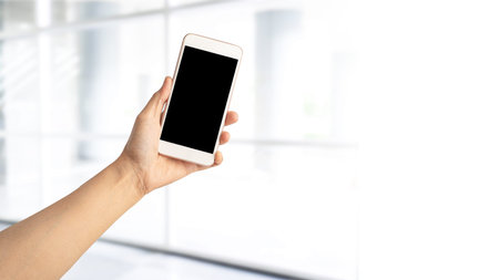 Asian active woman lady holding mobile phone to communicate about work at modern office