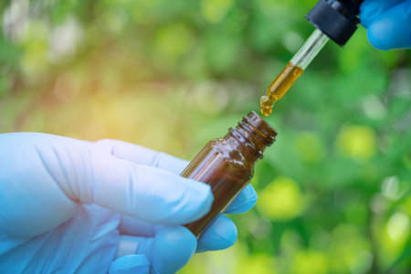 Doctors holding bottle of herb oil plant product, droplet dosing, biology and ecology alternative...