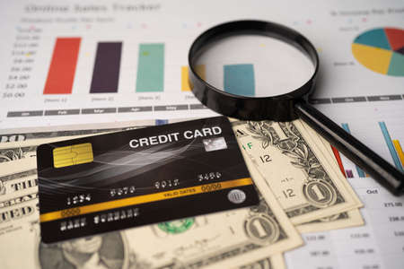 Credit card model on dollar banknotes with chart and graph paper. Finance development, Banking Account, Statistics, Investment Analytic research data economy, Stock exchange trading, Business company concept.の写真素材