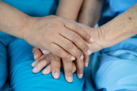 Holding hands Asian senior or elderly old lady woman patient with love, care, encourage and empathy...