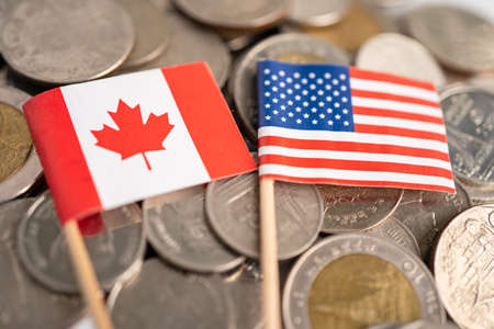 Stack of coins with USA America and Canada flag, finance concept.の写真素材