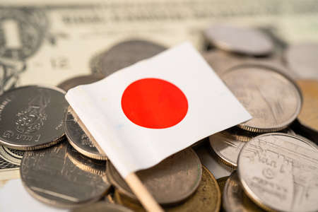 Stack of coins with Japan flag on white background.の写真素材