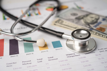 Stethoscope and US dollar banknotes on chart or graph paper, Financial, account, statistics and...