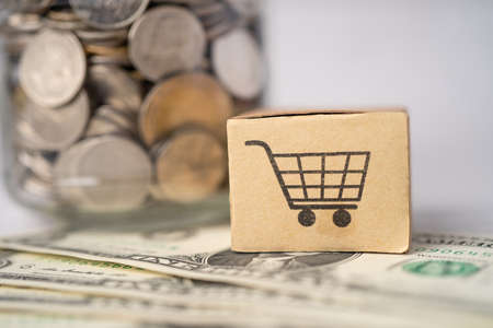 Shopping cart on box with US dollar banknotes background; Banking Account, Investment Analytic research data economy, trading, Business import export online company concept.の写真素材