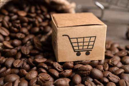 Box with shopping cart symbol on coffee beans, Import Export Shopping online or eCommerce delivery service store product shipping, trade, supplier concept.の写真素材