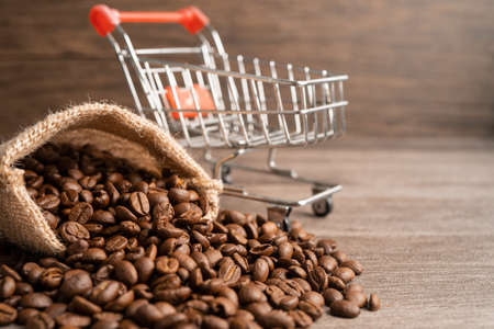 Box with shopping cart on coffee beans, Import Export Shopping online or eCommerce delivery service store product shipping, trade, supplier concept.の写真素材