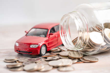 Car on coins background; Car loan, Finance, saving money, insurance and leasing time concepts.の写真素材