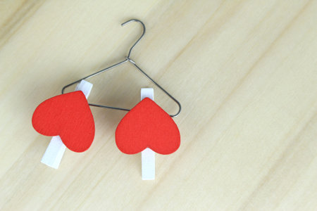 Red hearts hanging on the hangerの写真素材
