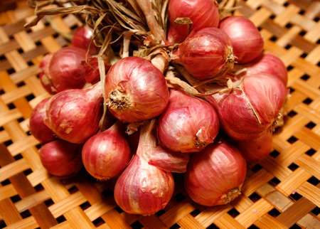 Shallot onions in a group on woodenの写真素材