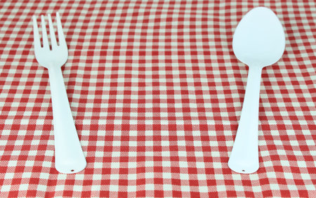fork and spoon on tablecloth for food serving backgroundの写真素材