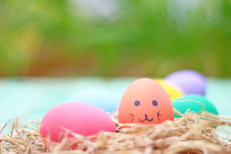 straw basket with easter eggs on wooden background